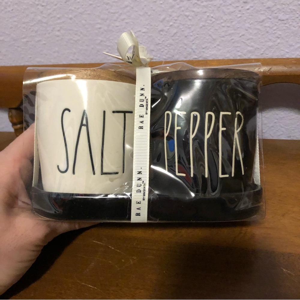 Rae Dunn salt and pepper holders with woofer lid and ceramic tray to hold them.